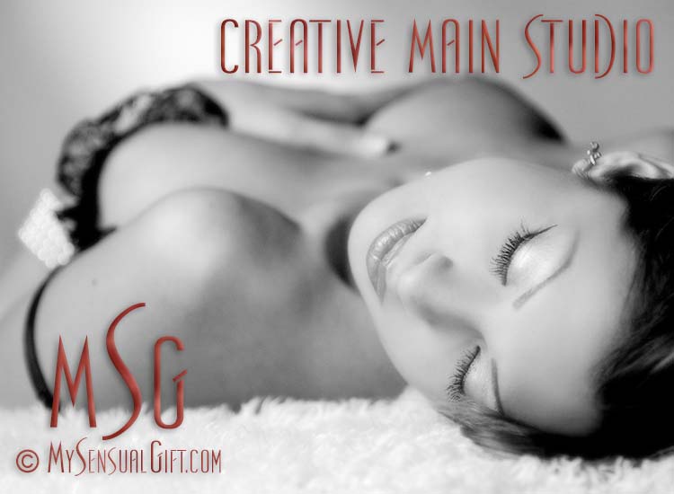 Beautiful topless portrait in black and white on studio rug. 